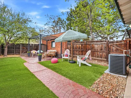 a view of a patio with couches chairs and a big yard