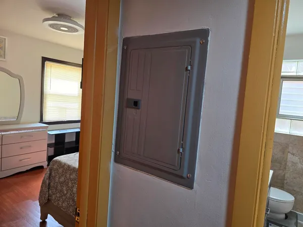 a room with a bed and a mirror