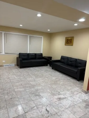 a living room with furniture and a dresser
