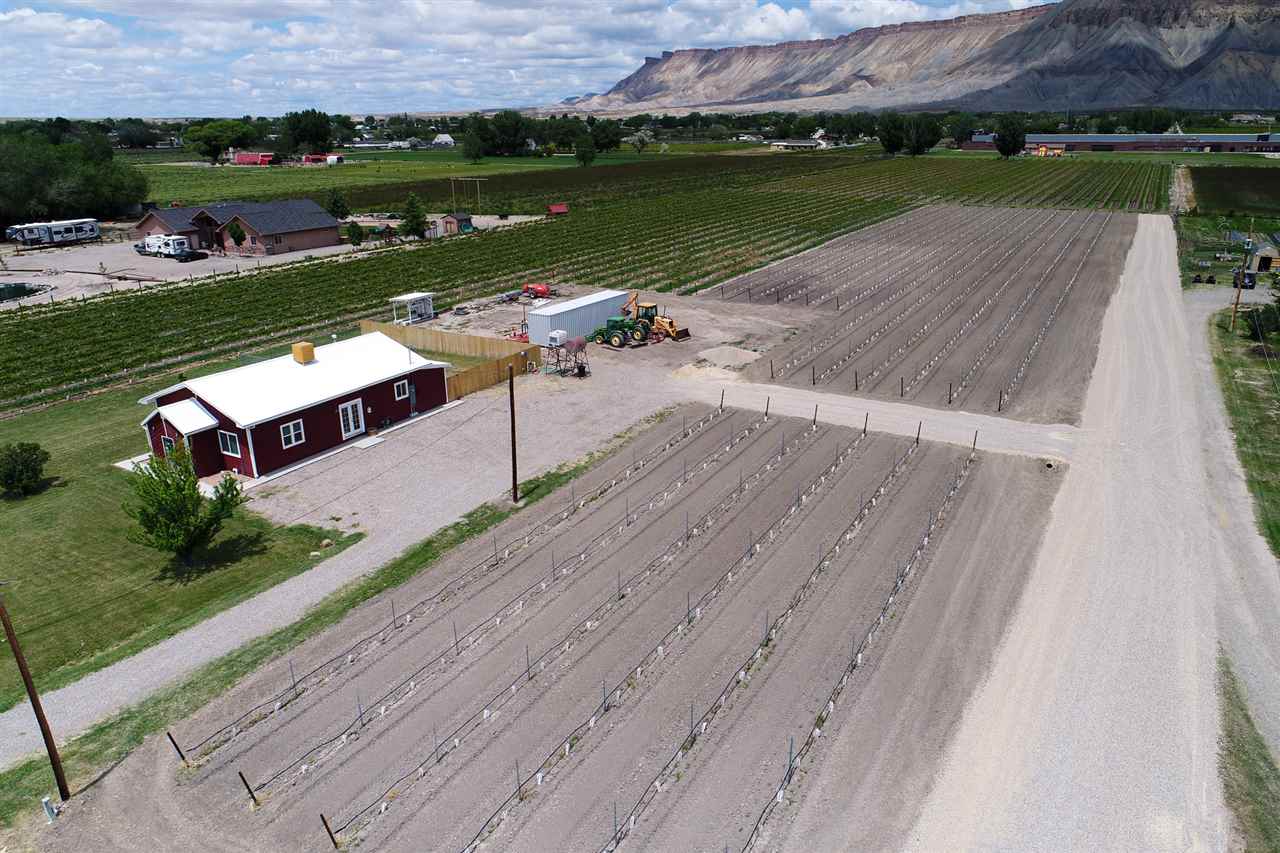3474 F Road Clifton, CO 81520 - Photo 2 of 15 an aerial view of a house with a garden and lake view