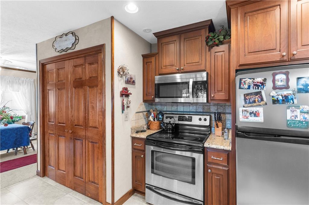 946 Crouser School Road Sandy Lake, PA 16145 - Photo 13 of 41 a kitchen with granite countertop cabinets stainless steel appliances and a counter space