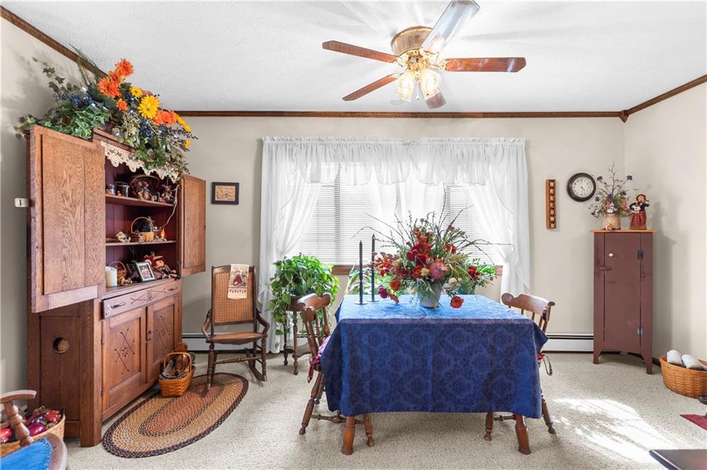 946 Crouser School Road Sandy Lake, PA 16145 - Photo 16 of 41 a living room with furniture and flowers