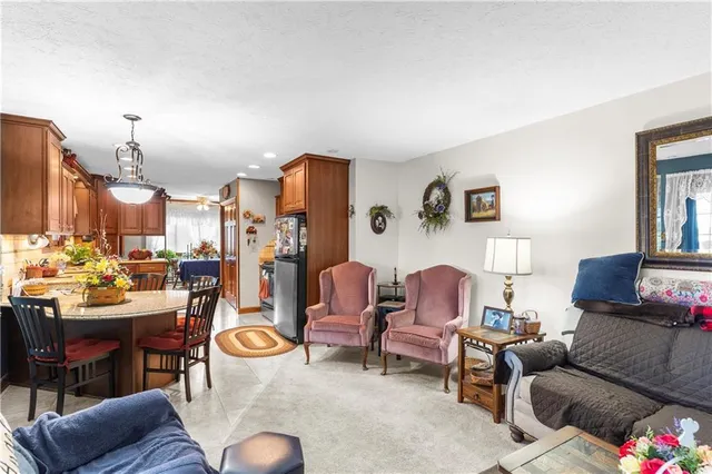 a living room with furniture kitchen view and a table