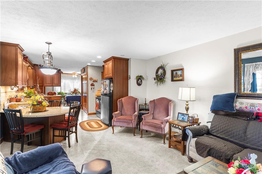 946 Crouser School Road Sandy Lake, PA 16145 - Photo 18 of 41 a living room with furniture kitchen view and a table