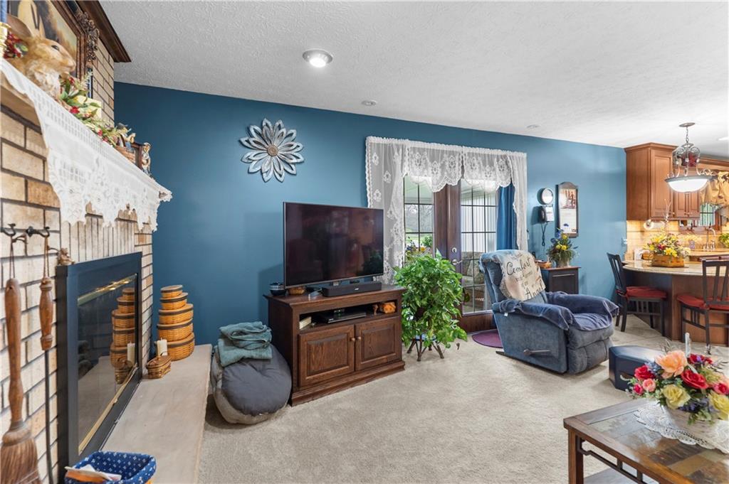 946 Crouser School Road Sandy Lake, PA 16145 - Photo 19 of 41 a living room with furniture a flat screen tv and a refrigerator