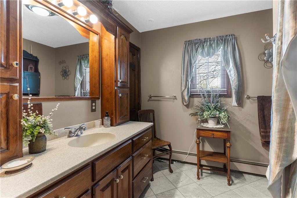946 Crouser School Road Sandy Lake, PA 16145 - Photo 21 of 41 a bathroom with a sink and a mirror