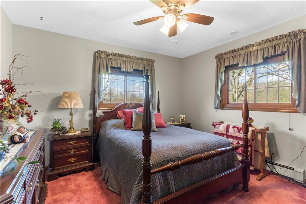 946 Crouser School Road Sandy Lake, PA 16145 - Photo 23 of 41 a bedroom with a bed and a chandelier