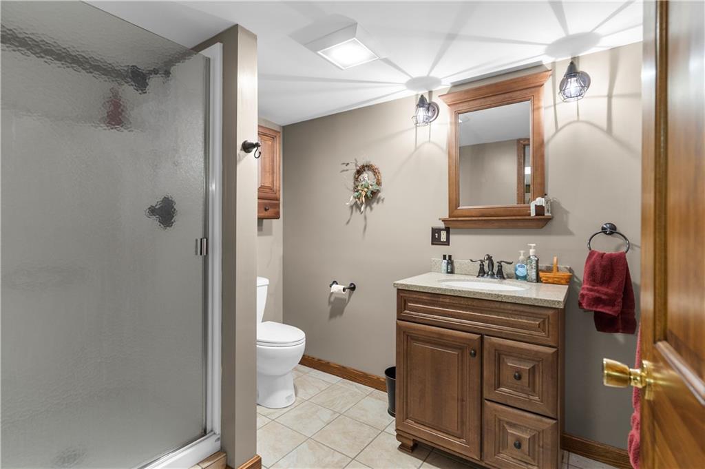 946 Crouser School Road Sandy Lake, PA 16145 - Photo 26 of 41 a bathroom with a granite countertop sink a toilet a shower and a mirror