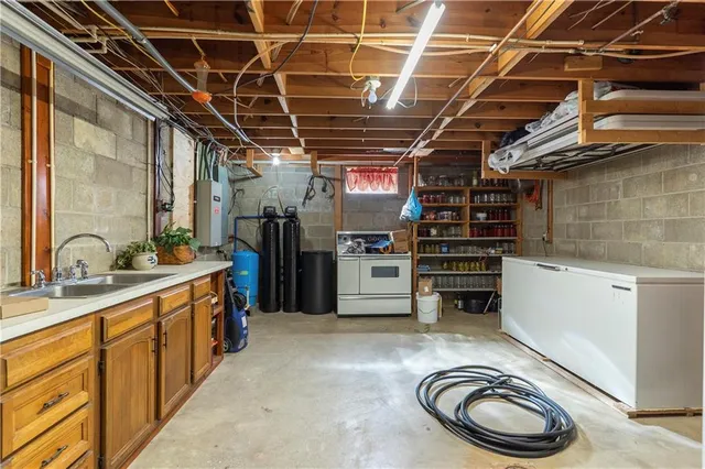 a kitchen with refrigerator and a sink