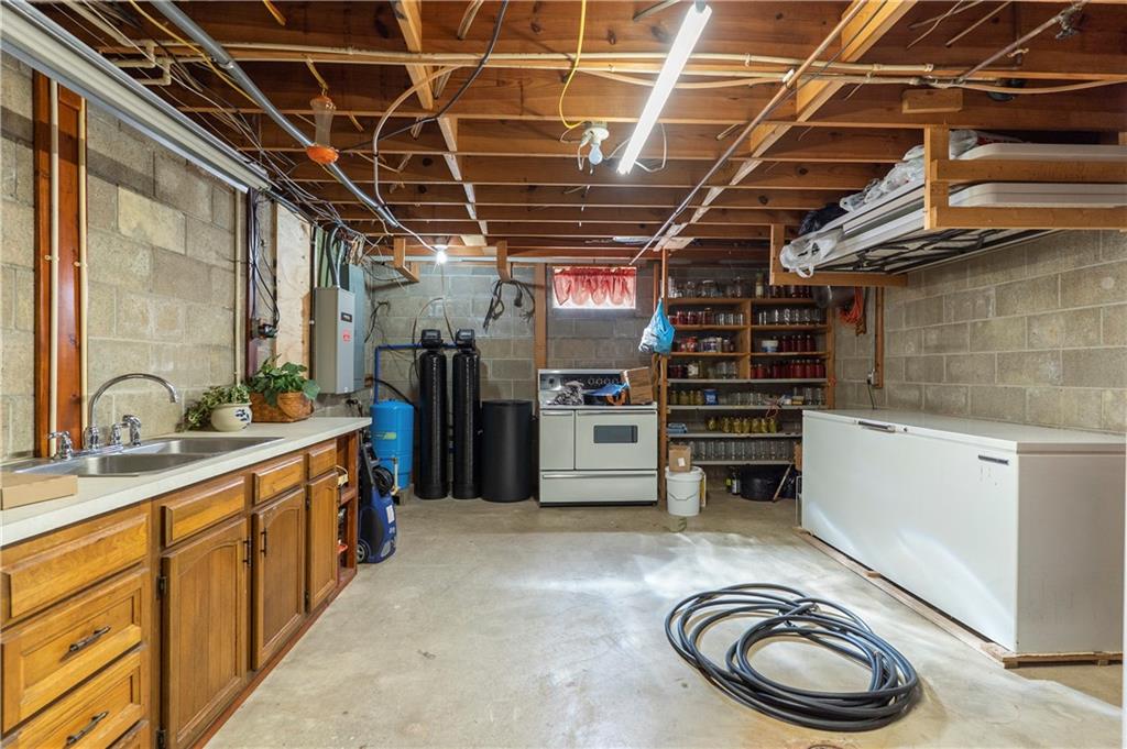 946 Crouser School Road Sandy Lake, PA 16145 - Photo 27 of 41 a kitchen with refrigerator and a sink