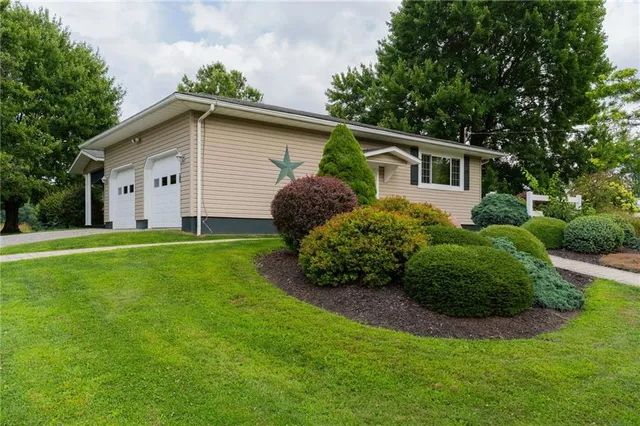 a house with green field in front of it
