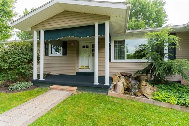 a view of house with backyard