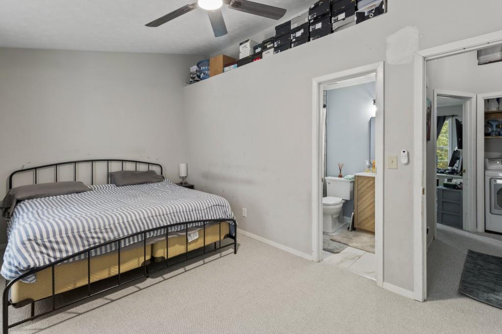 3509 Mt Vernon Circle Atlanta, GA 30340 - Photo 16 of 20 a spacious bedroom with a bed and a chandelier