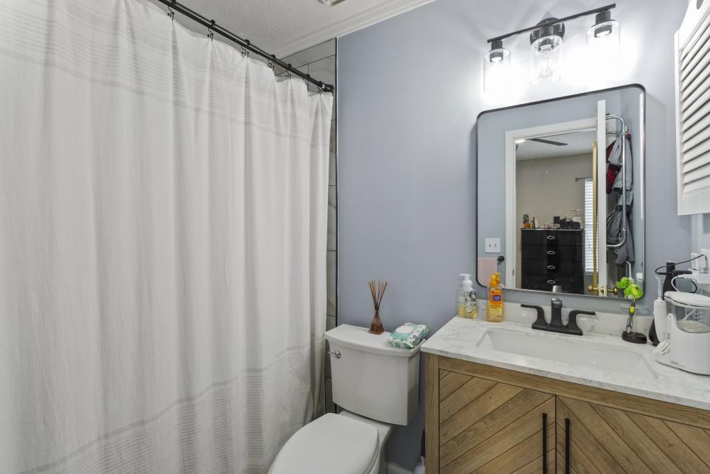3509 Mt Vernon Circle Atlanta, GA 30340 - Photo 18 of 20 a bathroom with a sink a toilet and shower curtain