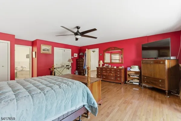 a bedroom with a bed and a tv