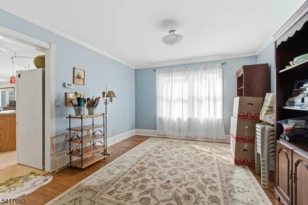 a view of a livingroom with workspace and a window