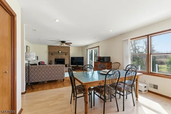 a dining room with furniture window and wooden floor