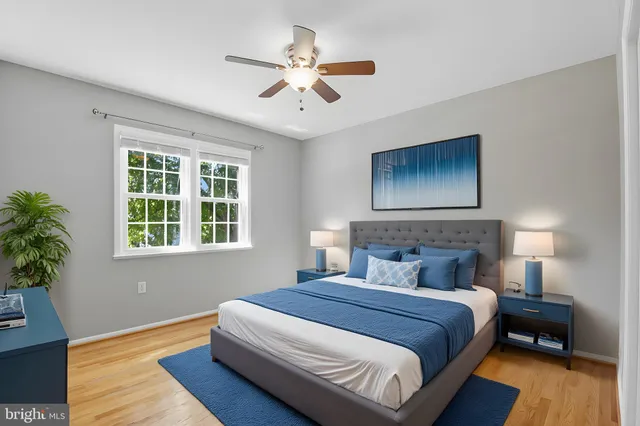 a bedroom with a large bed and a ceiling fan