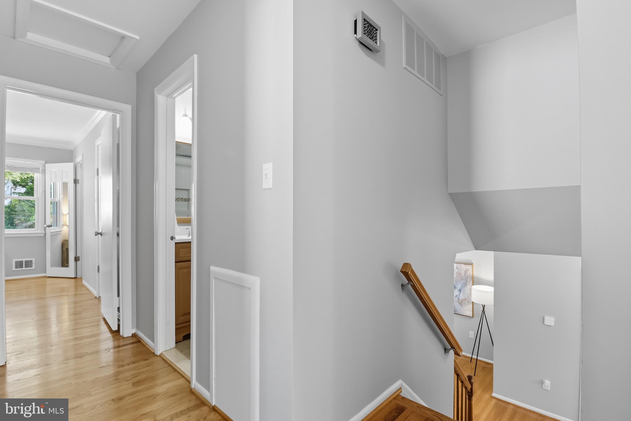 1503 Coat Ridge Road Herndon, VA 20170 - Photo 19 of 39 a view of a hallway with wooden floor and staircase