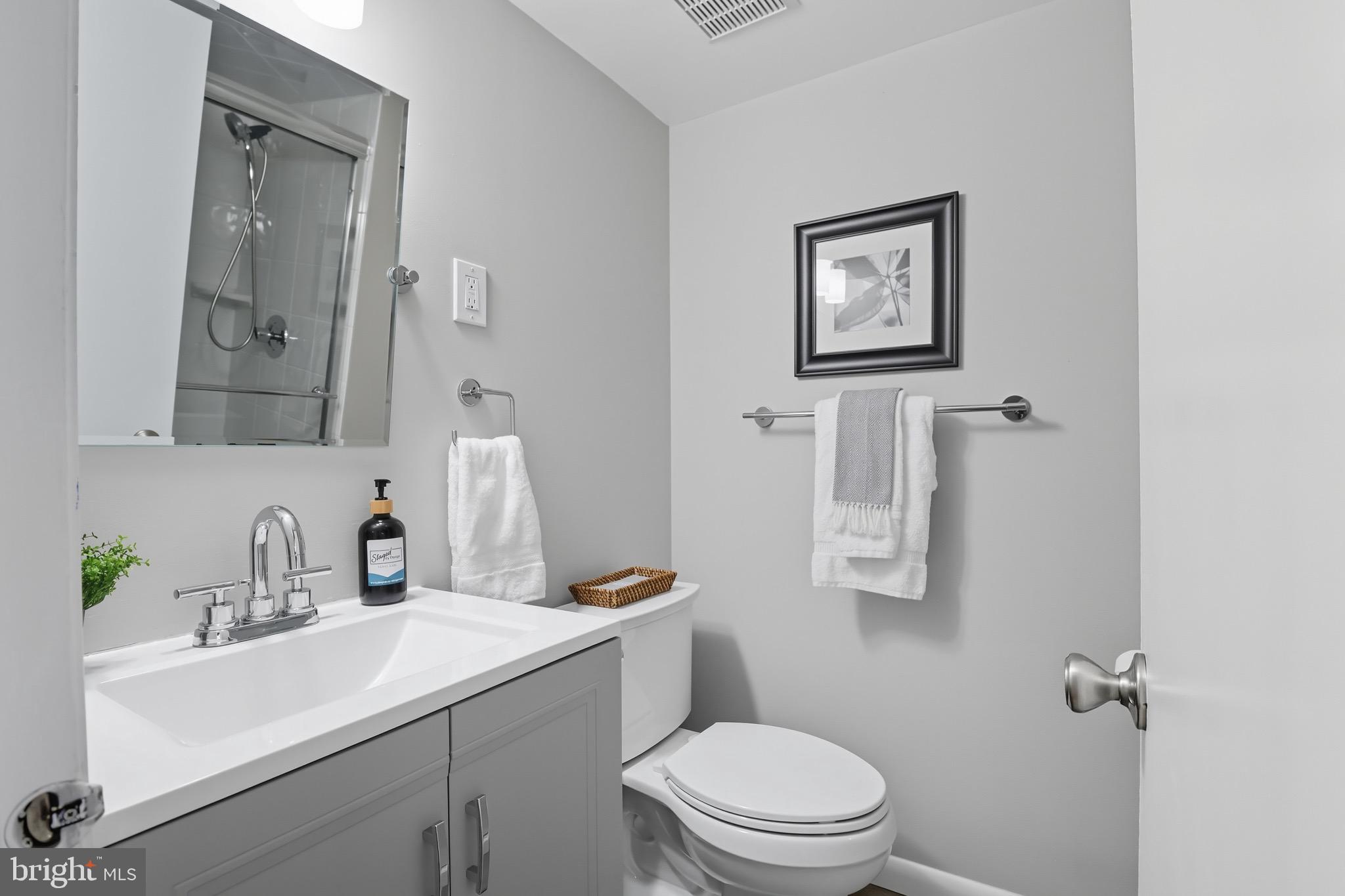 1503 Coat Ridge Road Herndon, VA 20170 - Photo 22 of 39 a bathroom with a toilet sink and mirror