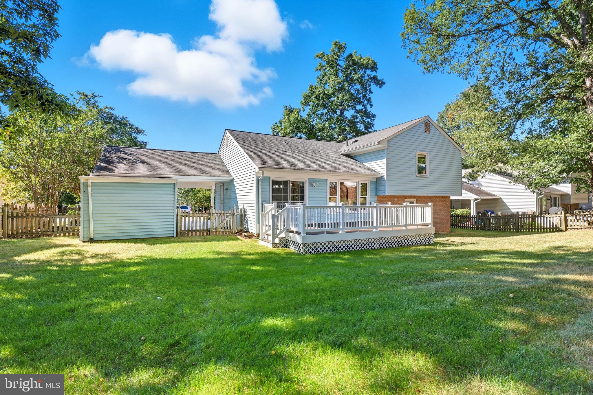 1503 Coat Ridge Road Herndon, VA 20170 - Photo 28 of 39 a front view of a house with a garden and trees