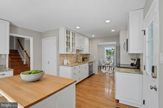 a kitchen with sink cabinets and wooden floor