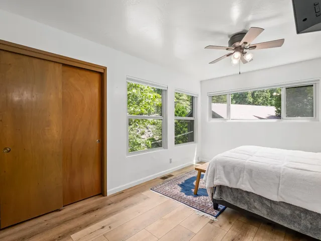 a bedroom with double bed and a chandelier
