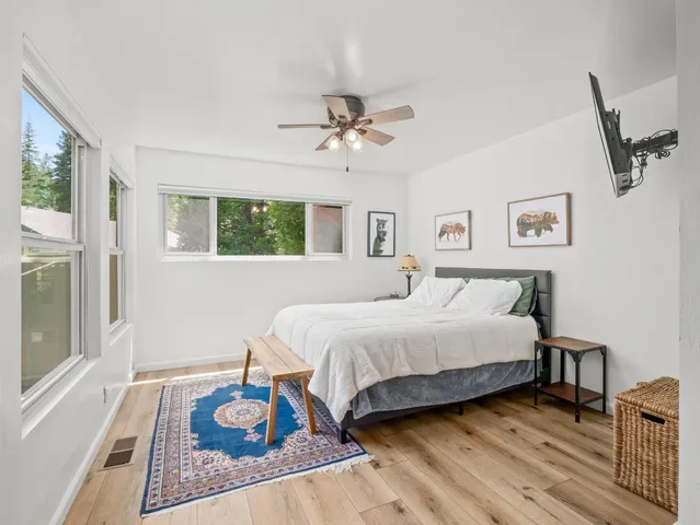 a bedroom with a large bed and a flat screen tv