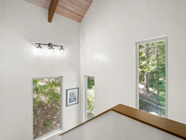 a living room with furniture a flat screen tv and a large window