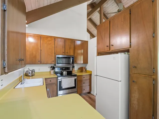 a view of a patio with table and chairs and couches