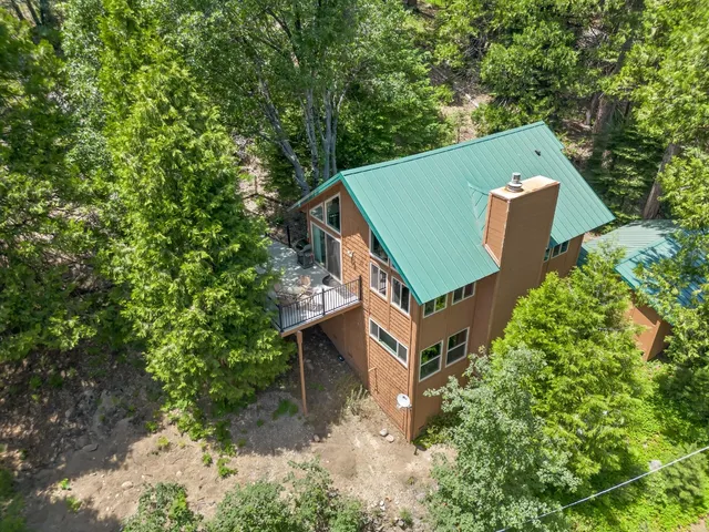 an aerial view of a house with a yard and outdoor space
