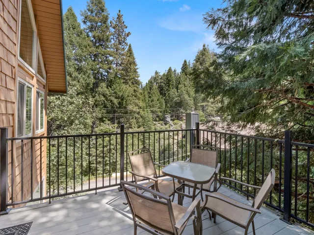 a roof deck with table and chairs a barbeque and potted plants