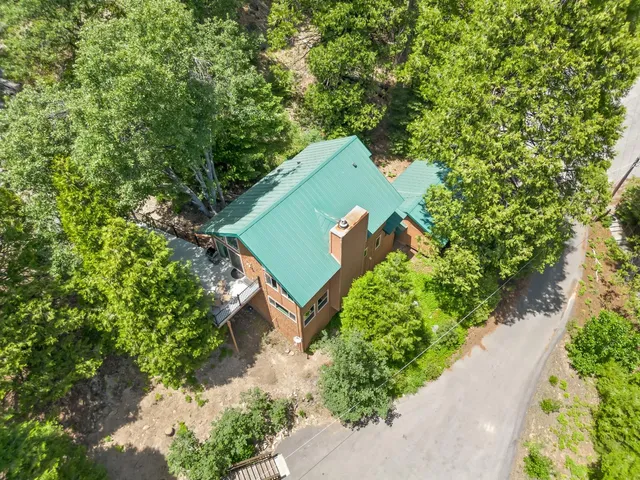 an aerial view of a house with a yard