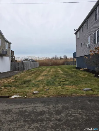a large body of water with a building in the background