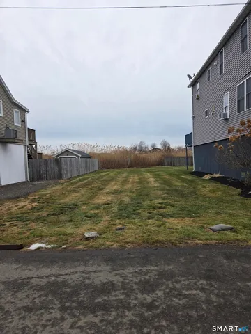 a large body of water with a building in the background