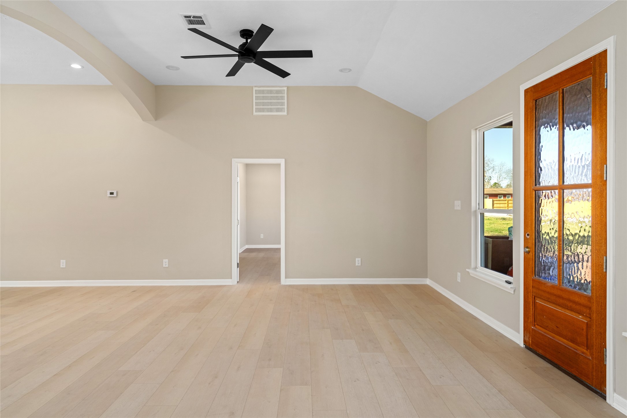 4654 North Teague Street Rosharon, TX 77583 - Photo 27 of 46 Front entry spotlight: warm
wood door, abundant natural
light, and a versatile, open
living space. Vaulted ceilings
and minimalist walls offer
endless décor possibilities.