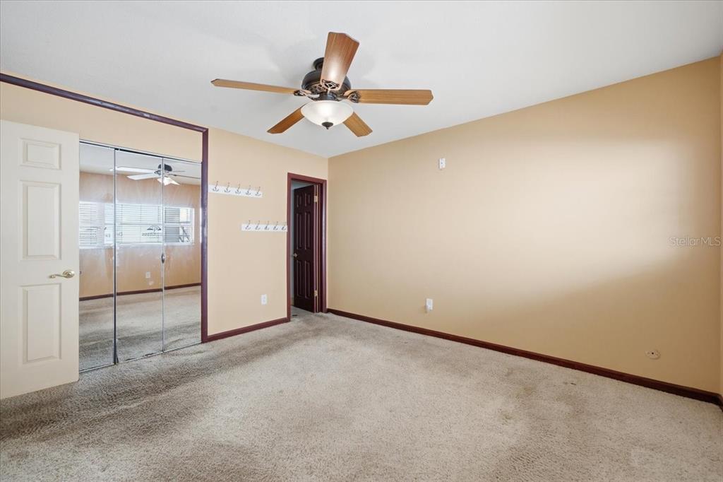 231 Skiff Point, Unit 7 Clearwater Beach, FL 33767 - Photo 21 of 55 an empty room and chandelier fan