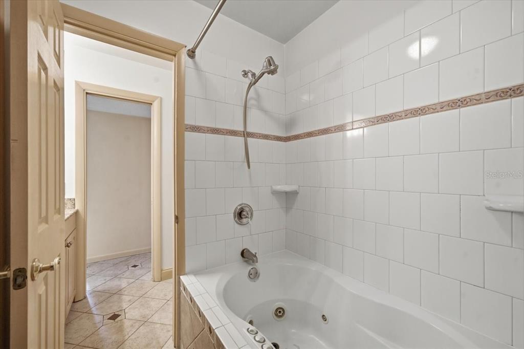 231 Skiff Point, Unit 7 Clearwater Beach, FL 33767 - Photo 25 of 55 a bathroom with a bathtub