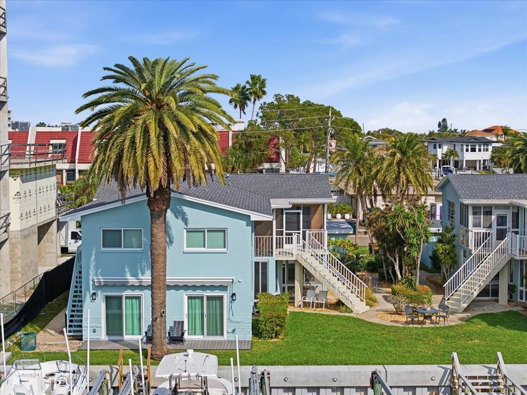 231 Skiff Point, Unit 7 Clearwater Beach, FL 33767 - Photo 39 of 55 a front view of a residential apartment building with a yard