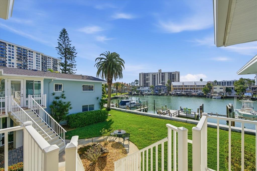 231 Skiff Point, Unit 7 Clearwater Beach, FL 33767 - Photo 8 of 55 a front view of a house with a garden and lake view