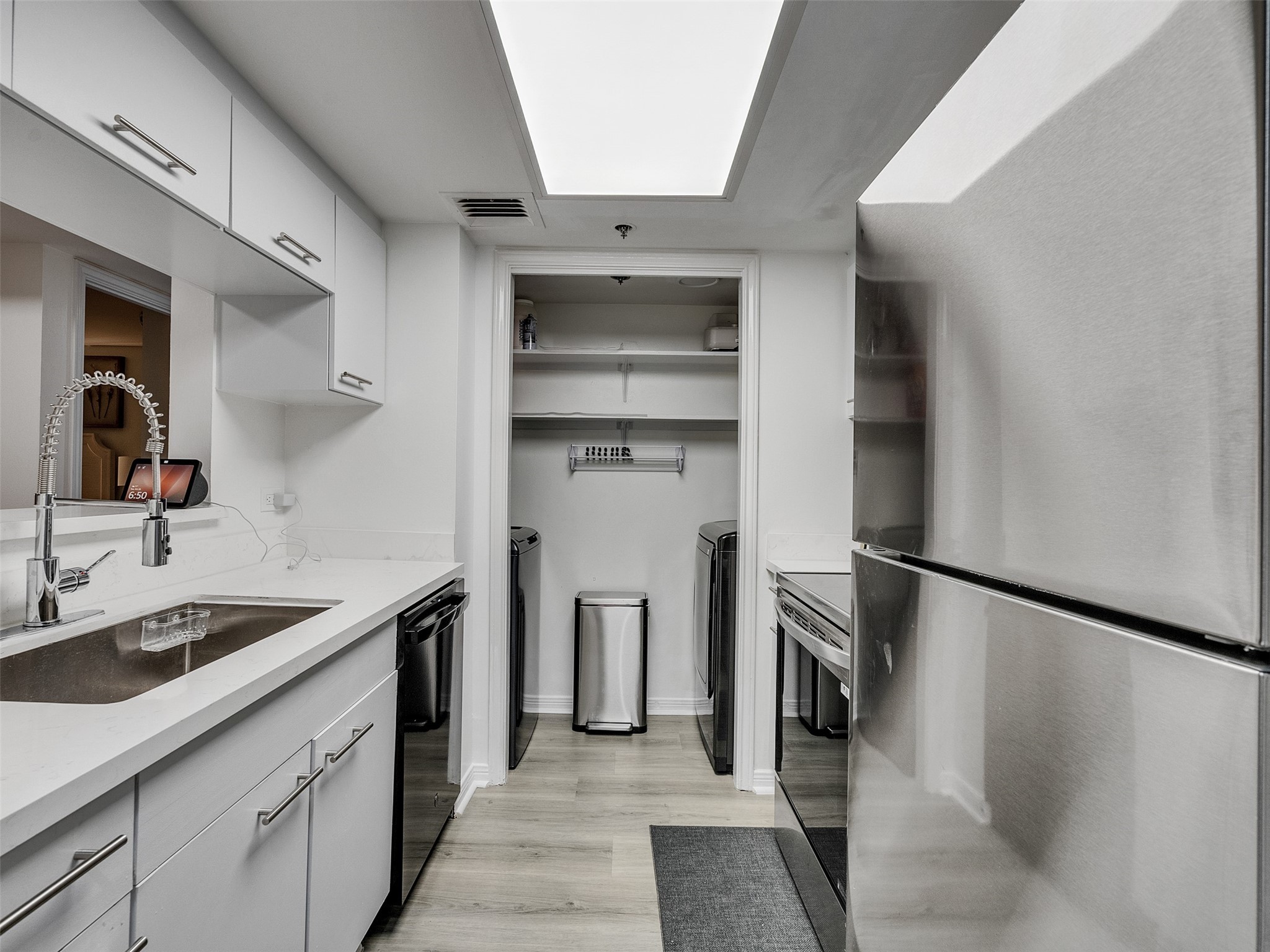 3525 Sage Road, Unit 812 Houston, TX 77056 - Photo 11 of 28 a kitchen with a sink stainless steel appliances and cabinets