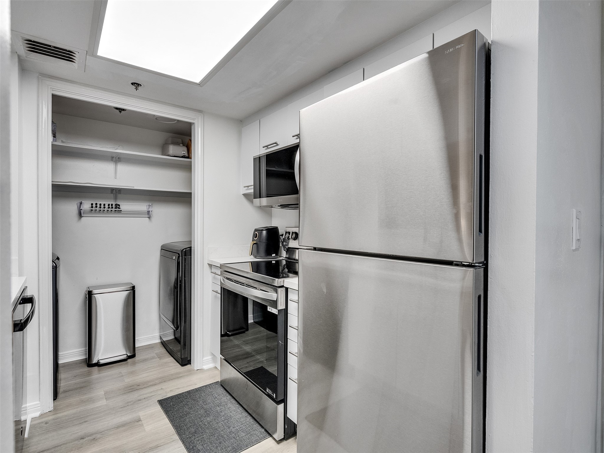3525 Sage Road, Unit 812 Houston, TX 77056 - Photo 13 of 28 a white refrigerator freezer and a stove sitting inside of a kitchen