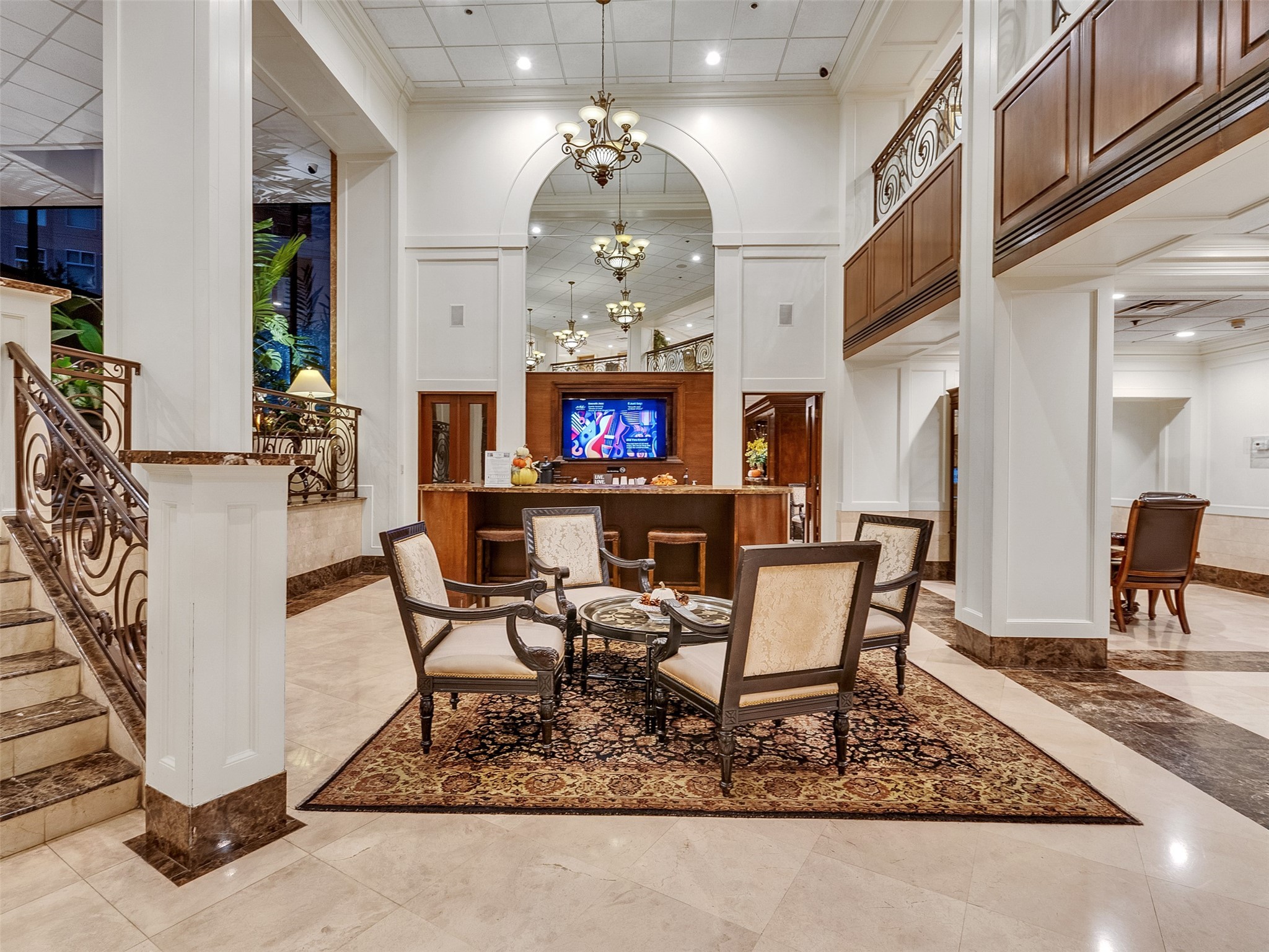 3525 Sage Road, Unit 812 Houston, TX 77056 - Photo 22 of 28 a dining room with wooden floor a chandelier a wooden table and chairs
