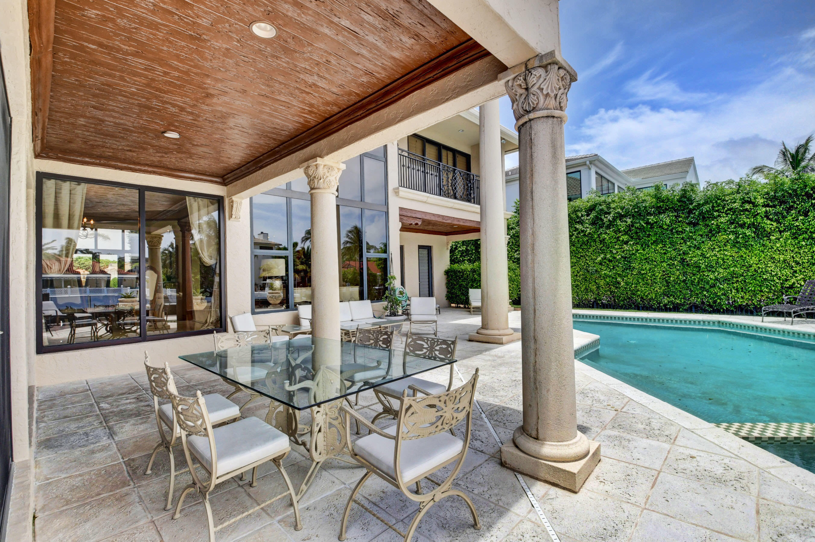 860 Northeast 79th Street Boca Raton, FL 33487 - Photo 108 of 109 a view of a patio with table and chairs potted plants with floor to ceiling window
