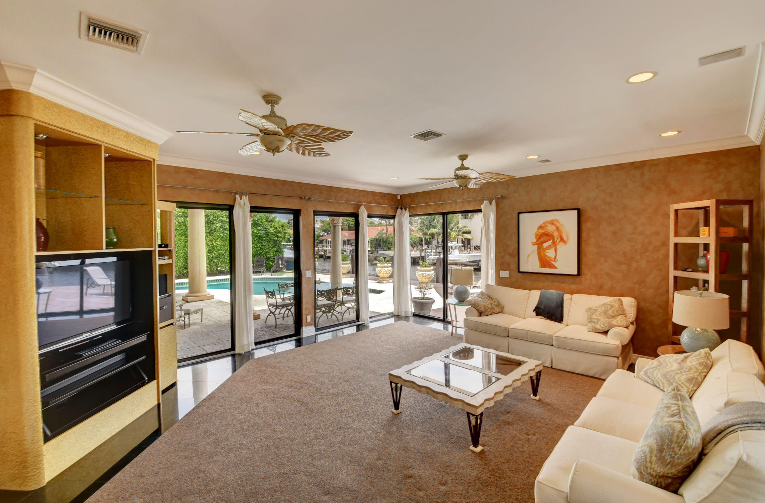 860 Northeast 79th Street Boca Raton, FL 33487 - Photo 27 of 109 a living room with furniture ceiling fan and a window