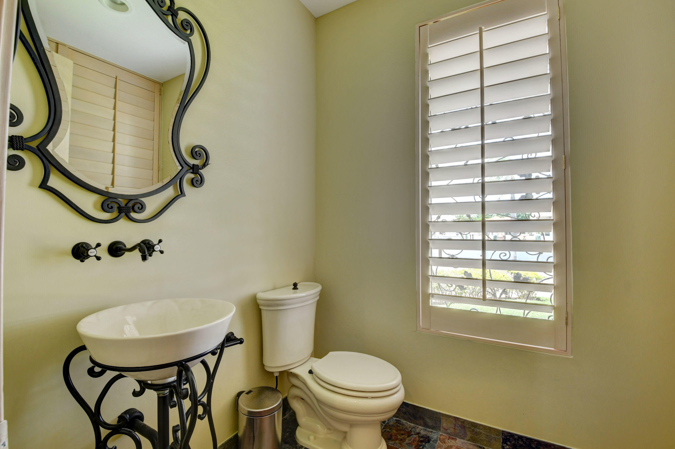 860 Northeast 79th Street Boca Raton, FL 33487 - Photo 36 of 109 a bathroom with a sink toilet and a mirror