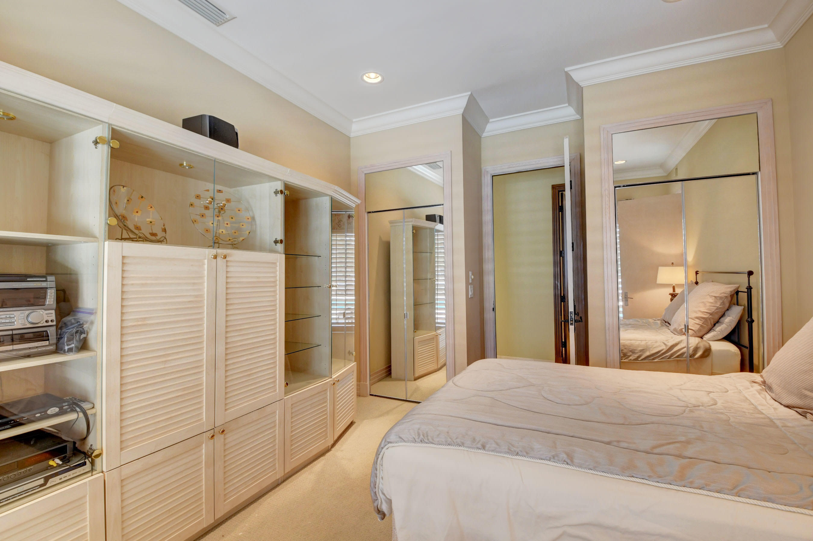 860 Northeast 79th Street Boca Raton, FL 33487 - Photo 38 of 109 a bedroom with a large bed and a glass door shower