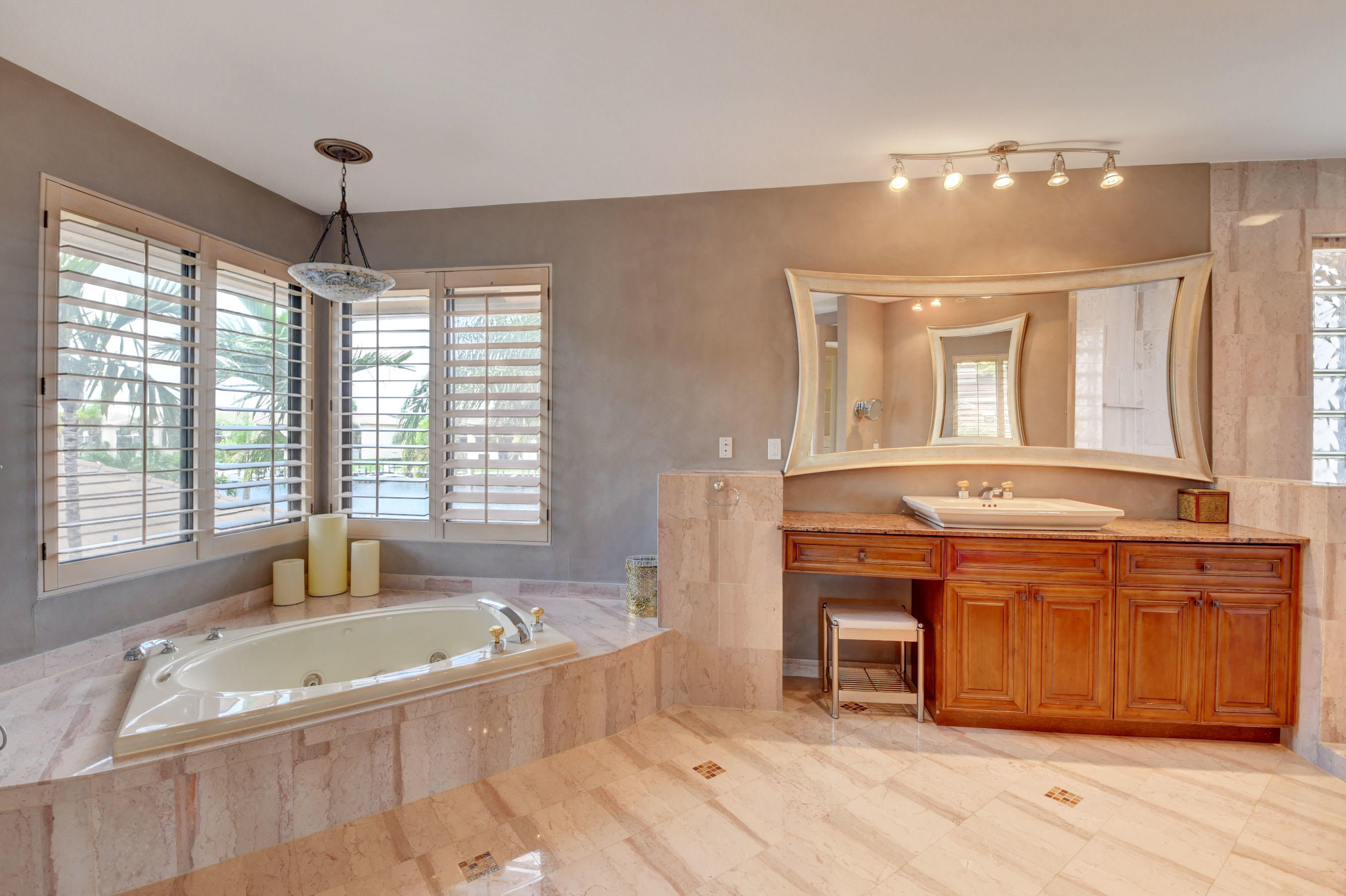 860 Northeast 79th Street Boca Raton, FL 33487 - Photo 54 of 109 a spacious bathroom with a tub sink and mirror