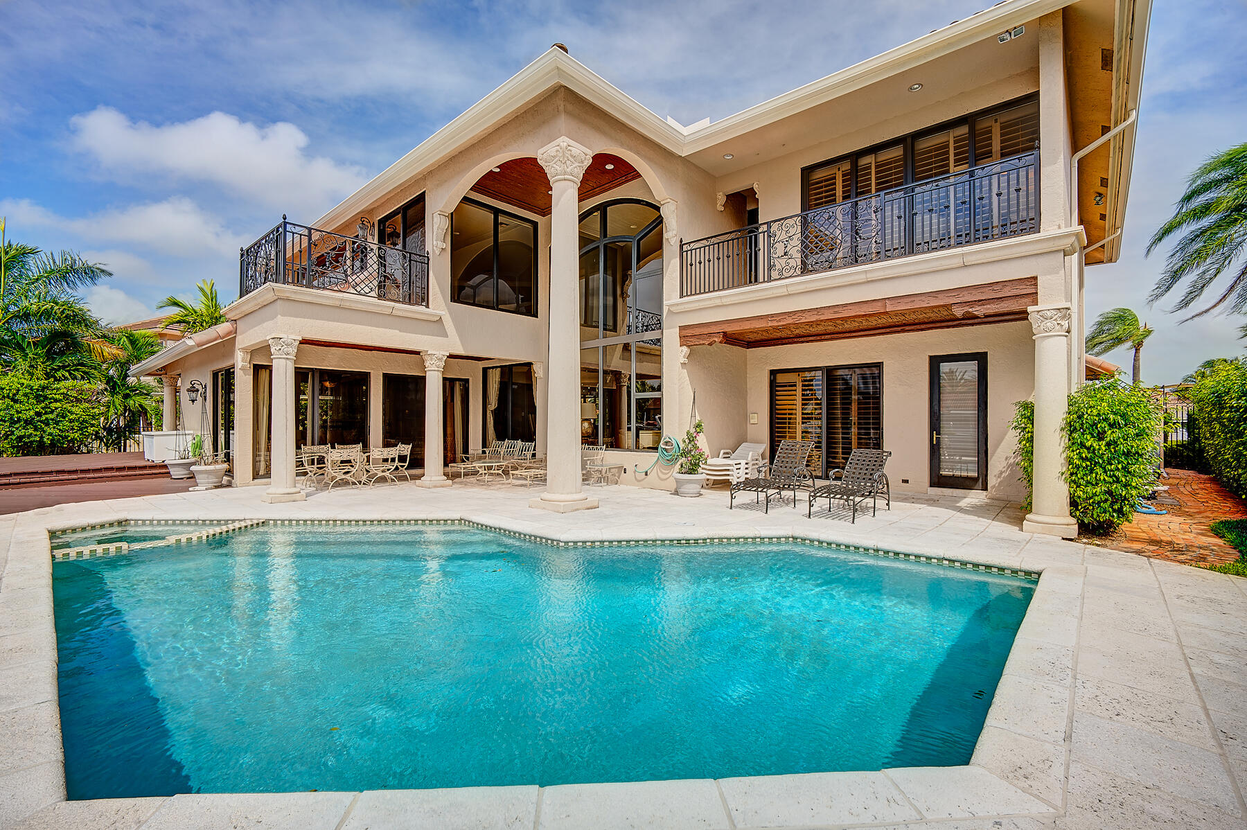 860 Northeast 79th Street Boca Raton, FL 33487 - Photo 6 of 109 a front view of a house with swimming pool having outdoor seating