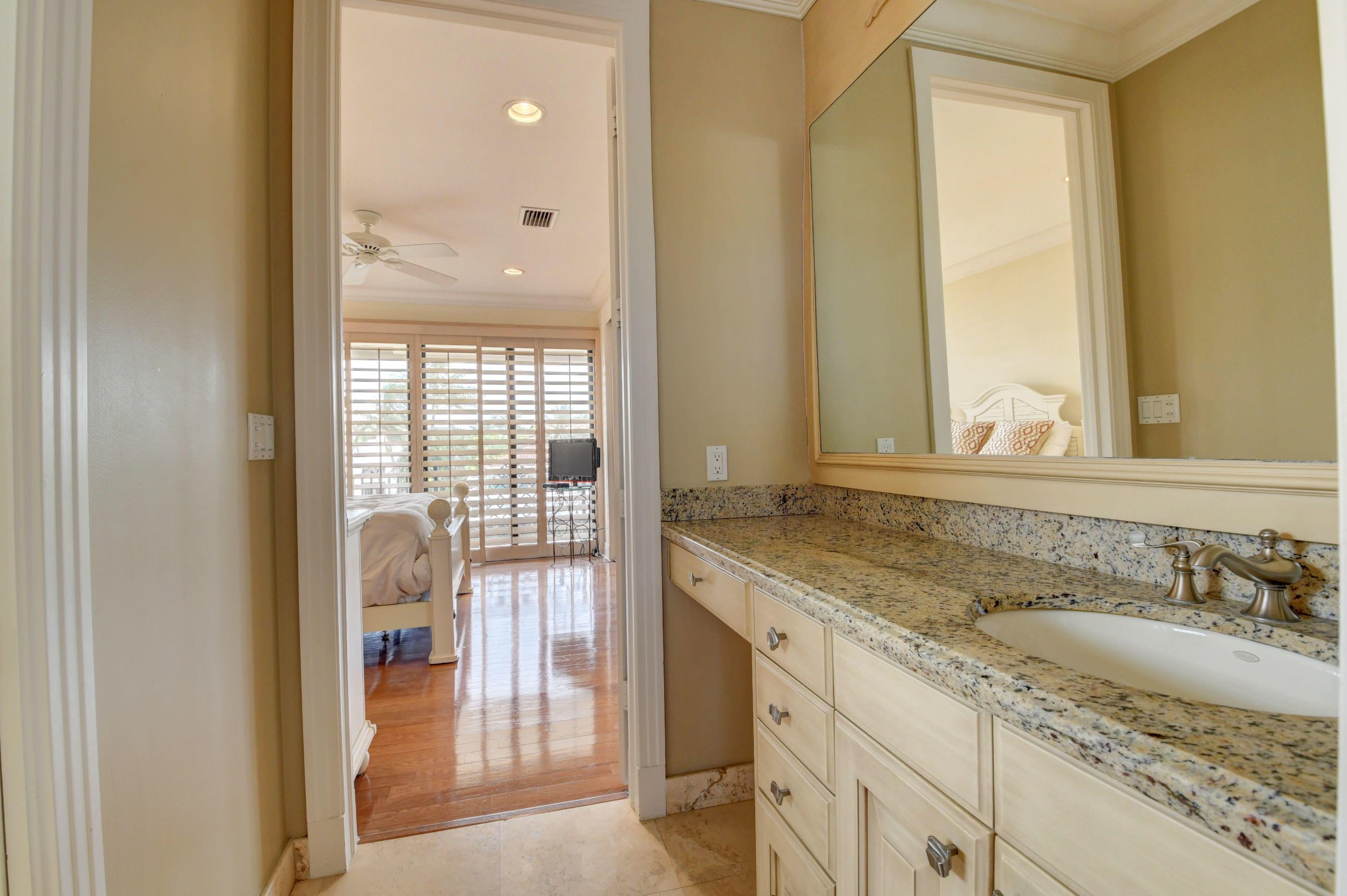 860 Northeast 79th Street Boca Raton, FL 33487 - Photo 62 of 109 a en suite bathroom with a granite countertop sink and a mirror